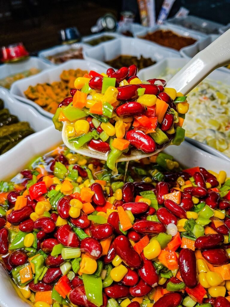 High-protein high-fiber dense bean salad with chickpeas, black beans and vegetables