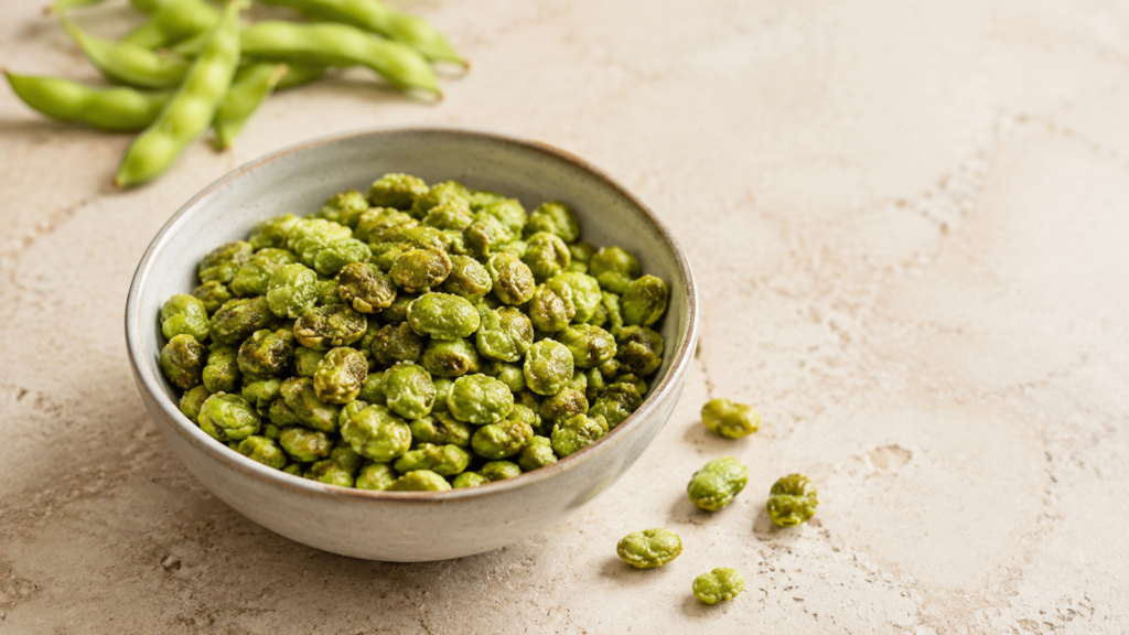 Bowl of dry roasted edamame on a light tabletop