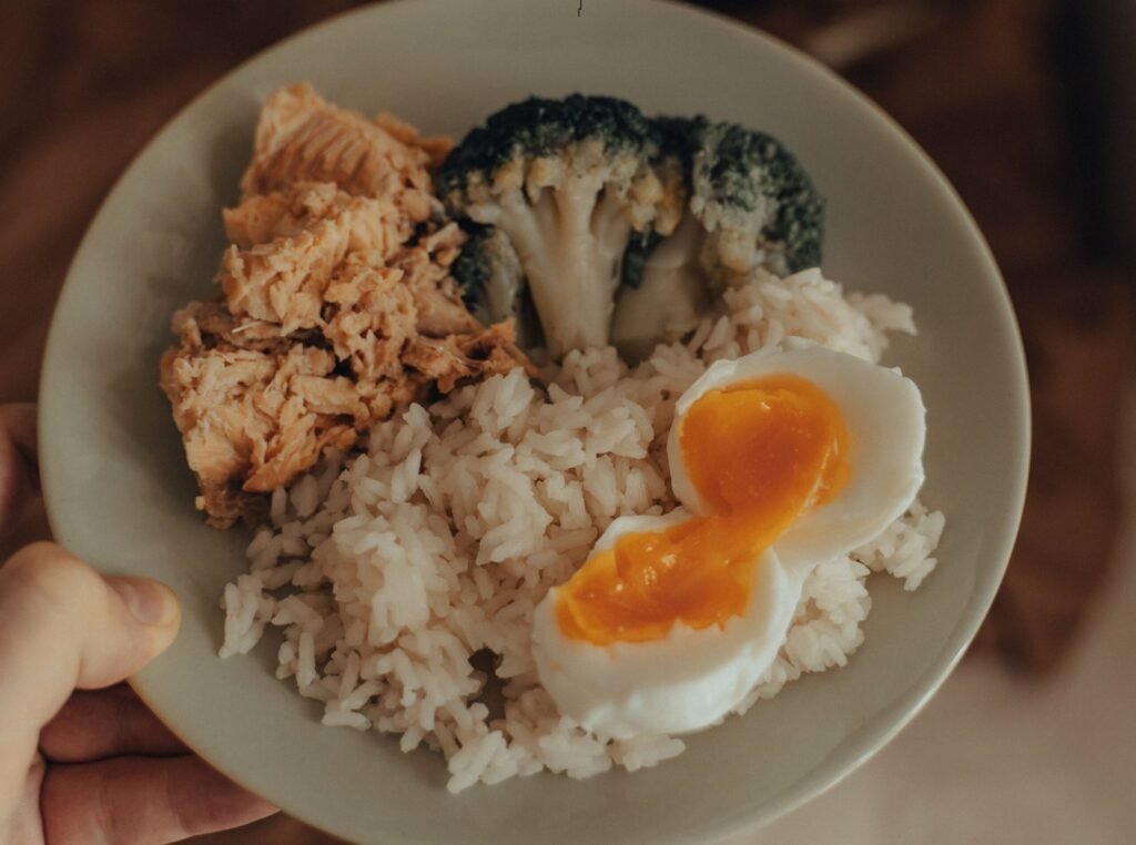 Protein rich foods including chicken breast, eggs, fish, yogurt, beans, lentils and tofu high in protein sources