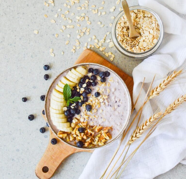 A realistic kitchen scene with plain yogurt, berries, oats